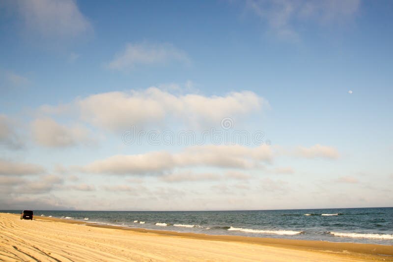 Minibus Car going far away at yellow sand seaside blue sky white