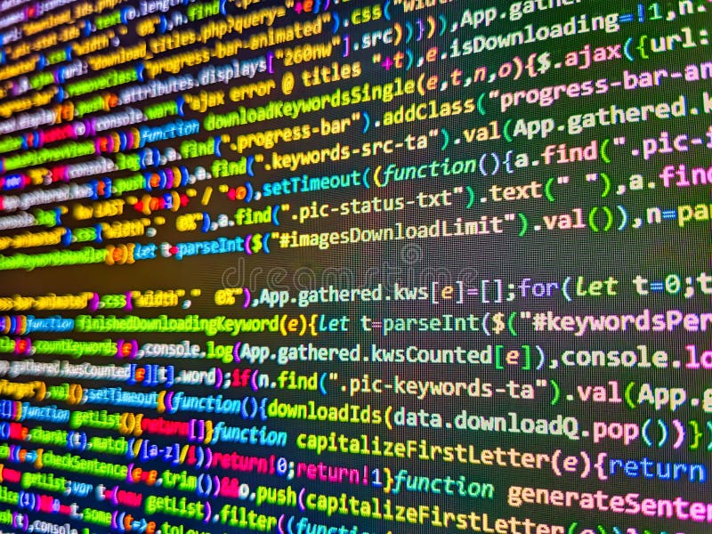 Minificated web development javascript code close up in sunset rays. Programmer developer screen, web app coding. Software royalty free stock photography