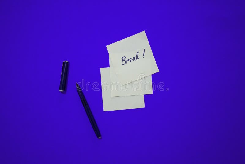 Minimal composition on a colorful pastel background with word `Break` writen on the little paper royalty free stock photography Minimal composition on a colorful pastel background with word `Break` writen on the little paper royalty free stock photography
