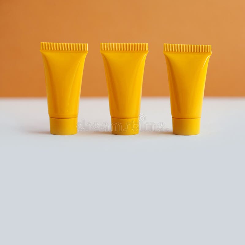 Download Minimal Cosmetic Design Three Yellow Cosmetic Tubes Package On Brown Background Blank Plastic Containers Simple Stock Image Image Of Glossy Beauty 143910831 Yellowimages Mockups