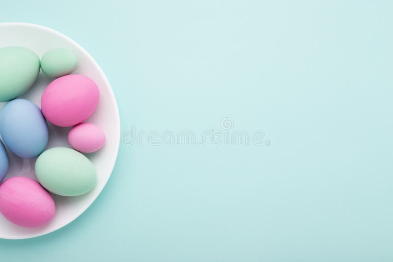 Minimal Easter card of eggs & plate on blue stock photos