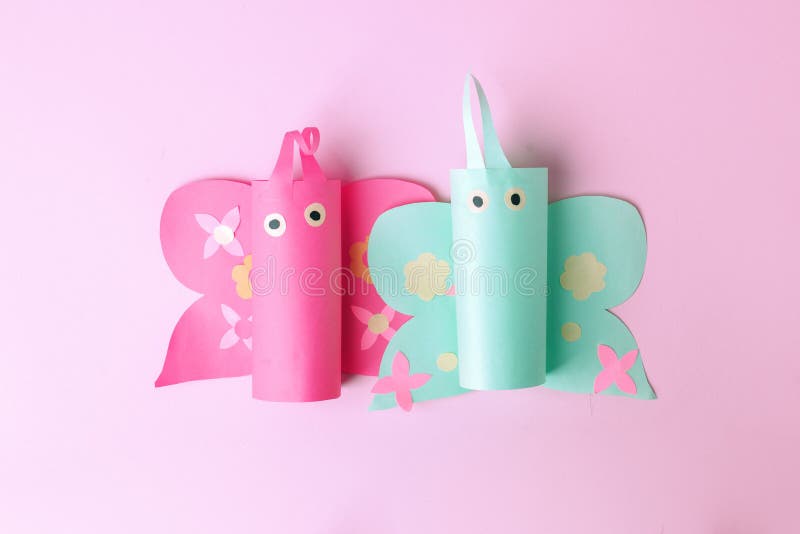 Minimal easter holiday spring summer time pink concept - couple of papaercraft handmade naive butterfly on pink candy color stock photography