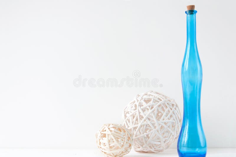 Minimal elegant composition with rattan balls and blue bottle stock photography Minimal elegant composition with rattan balls and blue bottle stock photography