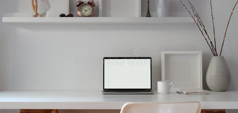 Minimal workspace with open blank screen laptop computer and mock up frame with decorations royalty free stock images Minimal workspace with open blank screen laptop computer and mock up frame with decorations royalty free stock images