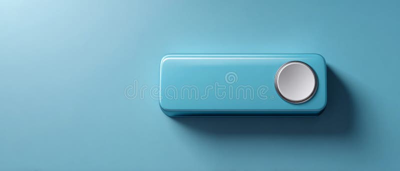 Minimalist blue rectangular device with a circular metallic button casting shadow on a smooth blue surface in soft lighting royalty free stock images