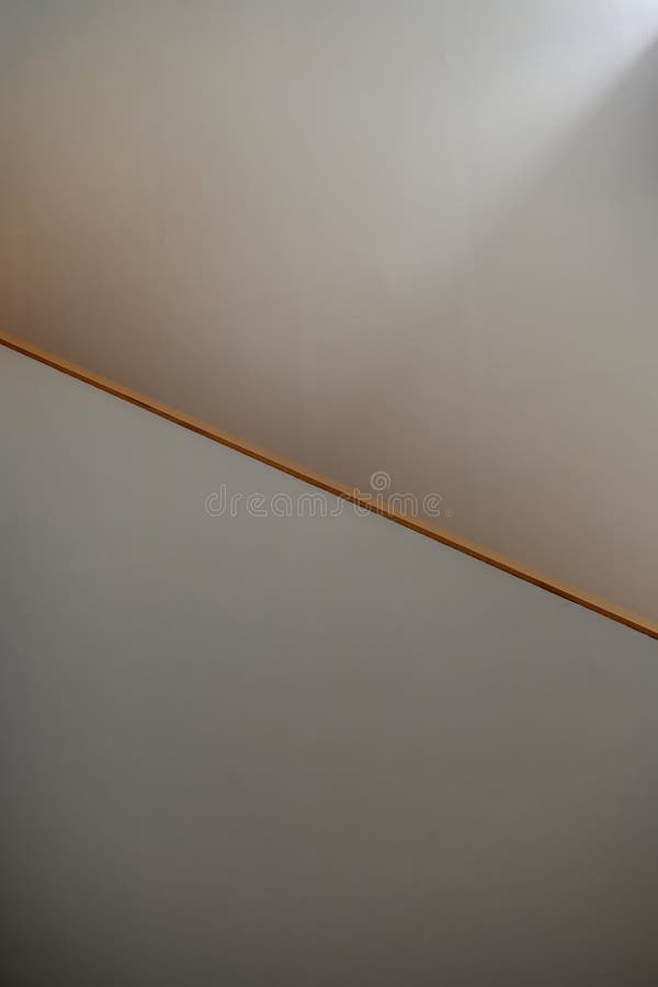 Minimalist diagonal composition on a staircase wall simple line separating light and shadow an indoor with clean geometry photographie stock libre de droits
