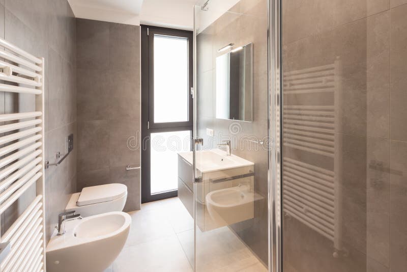 Minimalist modern bathroom with large tiles royalty free stock photography Minimalist modern bathroom with large tiles royalty free stock photography