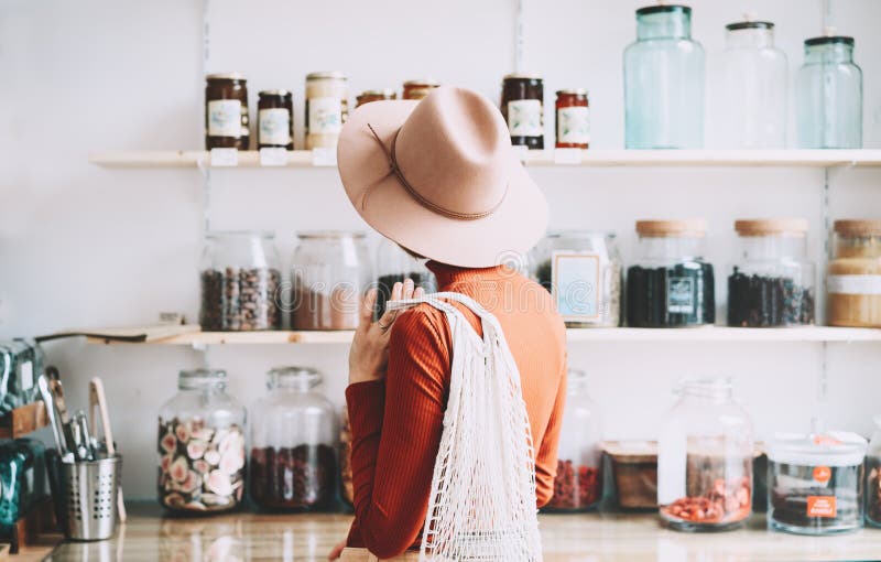 Young woman in zero waste shop or plastic free store stock image Young woman in zero waste shop or plastic free store stock image