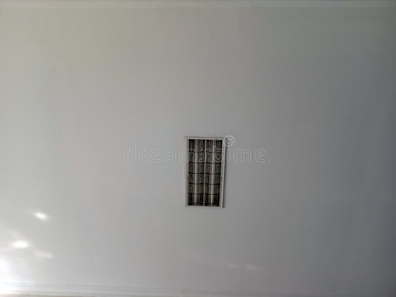 Minimalist White Ceiling with Single Square Light Fixture royalty free stock images