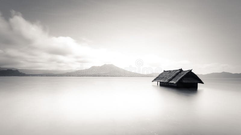 Minimalistic image of abandoned house floating on water stock photo