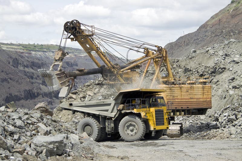 Loading the iron ore into heavy dump truck at the opencast mining