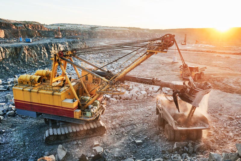 Mining. excavator loading granite or ore into dump truck stock photography Mining. excavator loading granite or ore into dump truck stock photography