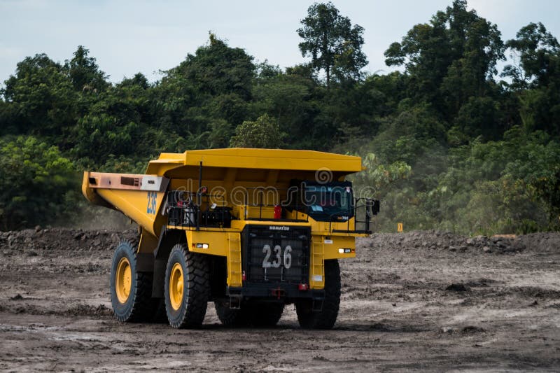 Mining truck mining machinery, to transport coal from open-pit as the Coal Production. Large quarry dump truck. Loading the rock in dumper. Loading coal into body truck. Production useful minerals.