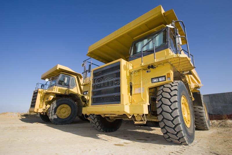 A picture of a big yellow mining trucks at worksite