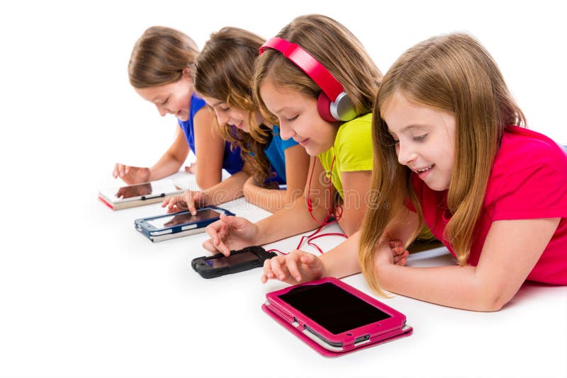 Sisters cousins kid girls with tech tablets and smatphones in a row lying on white background. Sisters cousins kid girls with tech tablets and smatphones in a row lying on white background