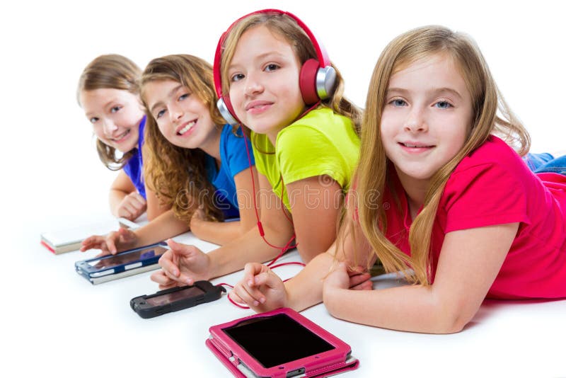 Sisters cousins kid girls with tech tablets and smatphones in a row lying on white background. Sisters cousins kid girls with tech tablets and smatphones in a row lying on white background