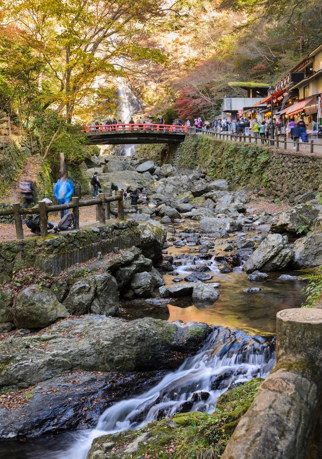 Minoo waterfall with red bridge in autumn at Minoo or Minoh national park in Osaka, Japan