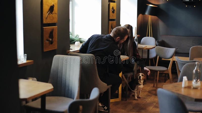 Minsk, Belarus - 11 January 2019: Candid image of young couple in a coffee shop. Caucasian man and woman sitting with a