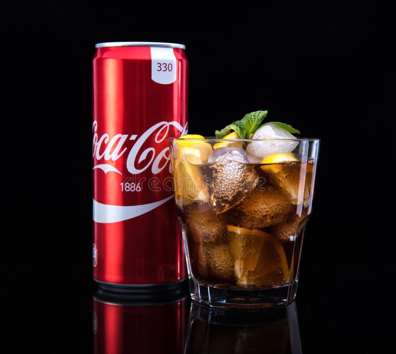 MINSK, BELARUS - JANUARY 05, 2017: Editorial photo can and glass of Coca-Cola with ice on dark background. Coca-Cola is stock photo MINSK, BELARUS - JANUARY 05, 2017: Editorial photo can and glass of Coca-Cola with ice on dark background. Coca-Cola is stock photo