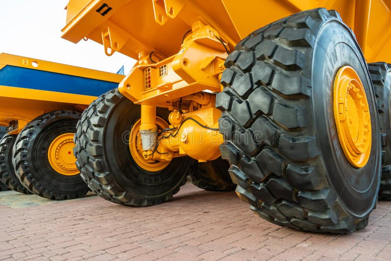 Minsk, Belarus June 2, 2022: Exhibition of new large-sized equipment. Cars for cargo transportation. Big black truck tire close-up