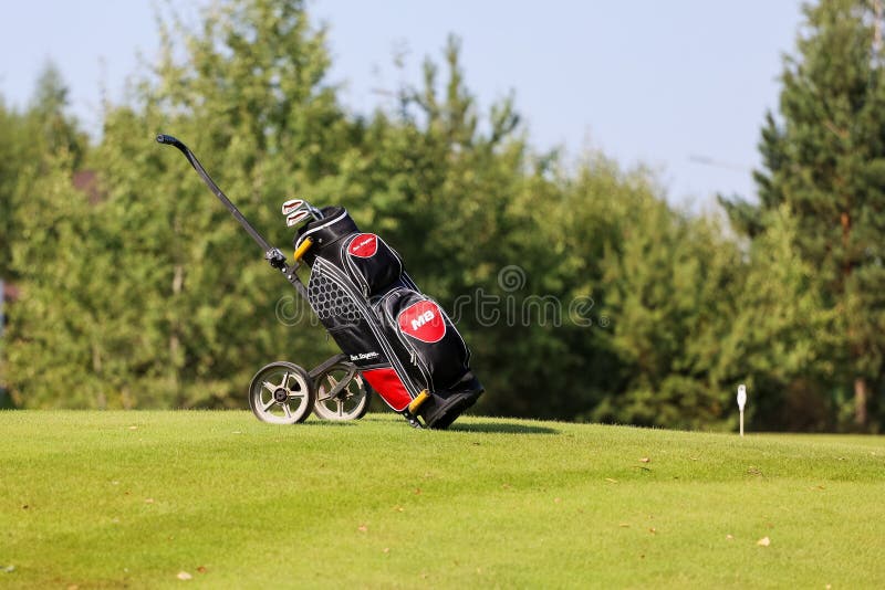 Minsk. Belarus - 25.07.2021 - Push-Pull Golf Carts. Green grass, trees.