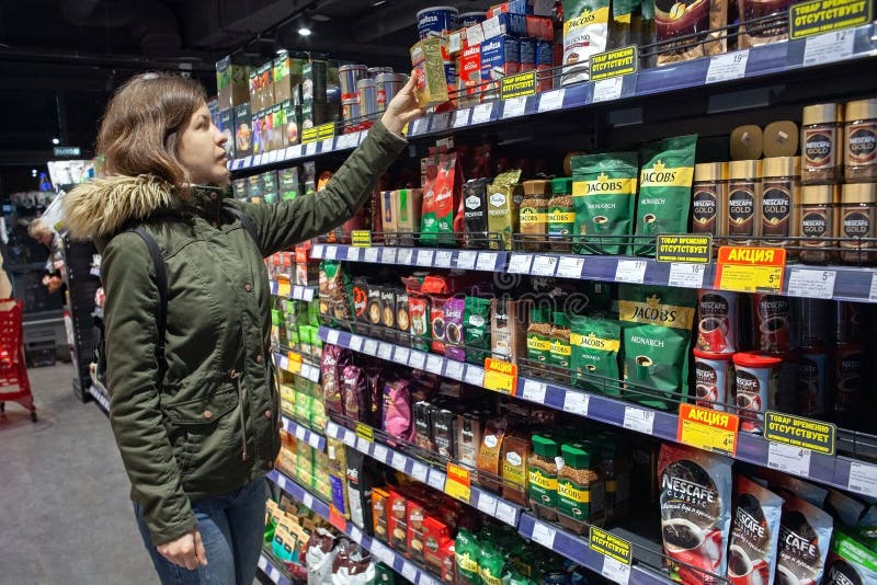 Shopper chooses coffee in the supermarket. Shopper chooses coffee in the supermarket.