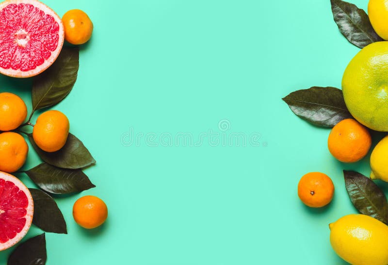 Mint Green background with different citrus fruits. Healthy food concept