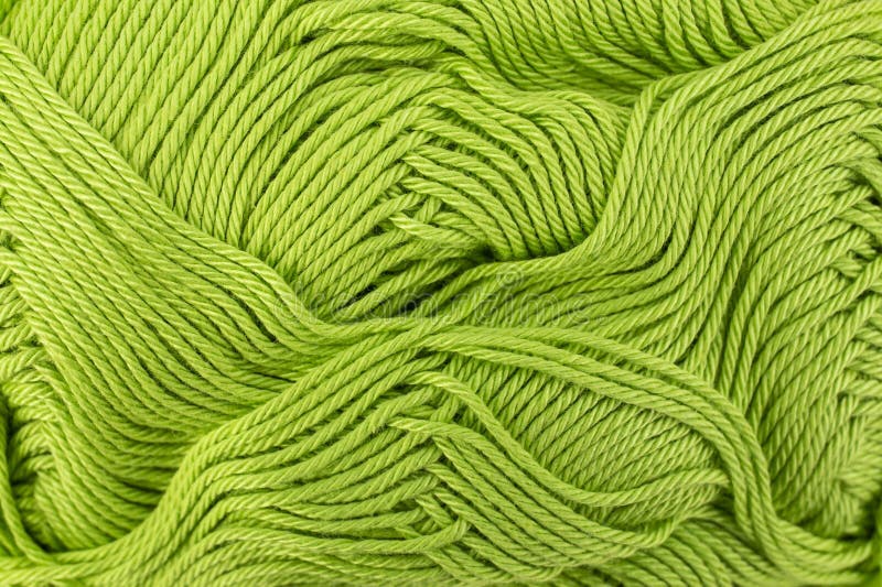 Mint green thread spool close up , abstract crochet backdrop stock photo