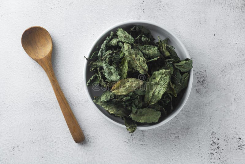 Mint Tea. Dry mint leaves in bow, over light background, isolated stock image Mint Tea. Dry mint leaves in bow, over light background, isolated stock image