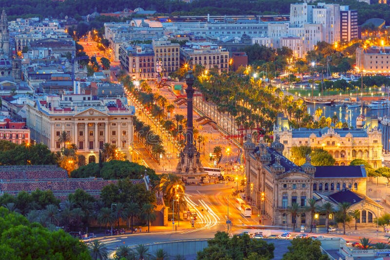 Aerial view over square Portal de la pau, and Port Vell marina and Columbus Monument at night in Barcelona, Catalonia, Spain. Aerial view over square Portal de la pau, and Port Vell marina and Columbus Monument at night in Barcelona, Catalonia, Spain