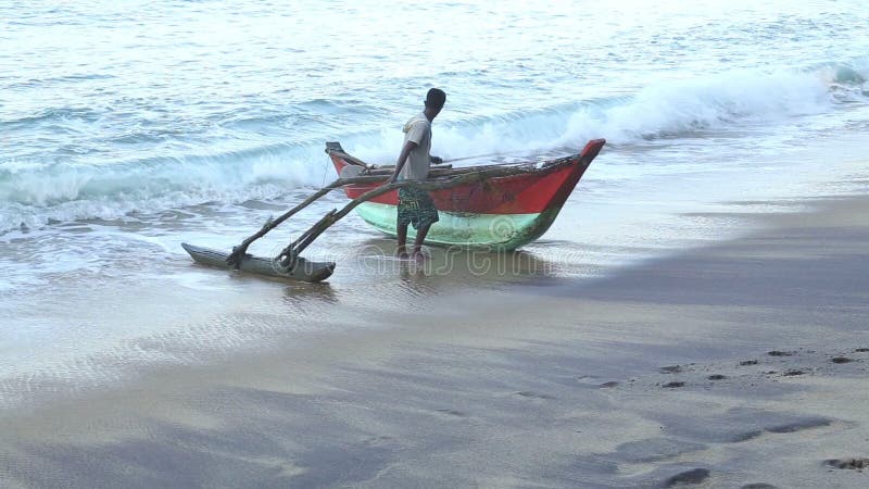 MIRISSA SRI LANKA - MARS 2014: Fiskare som får hans fartyg ut ur havet
