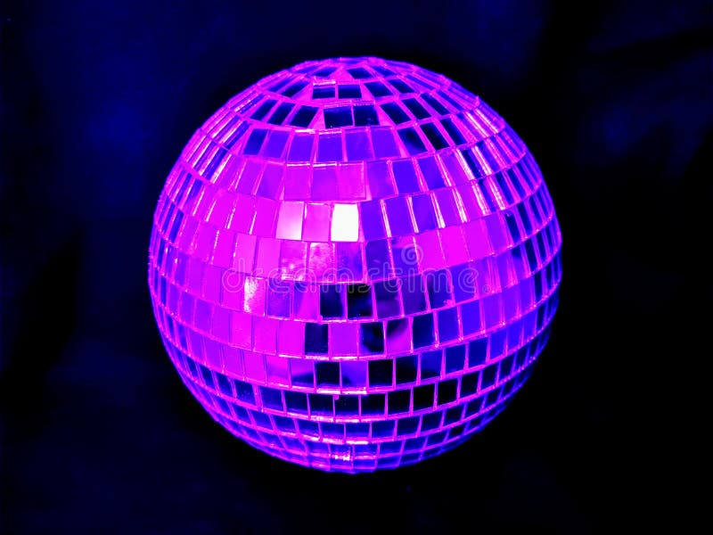 Mirror disco ball with pink lighting on a black  background at night. Disco violet light stock images, royalty-free photos and pictures