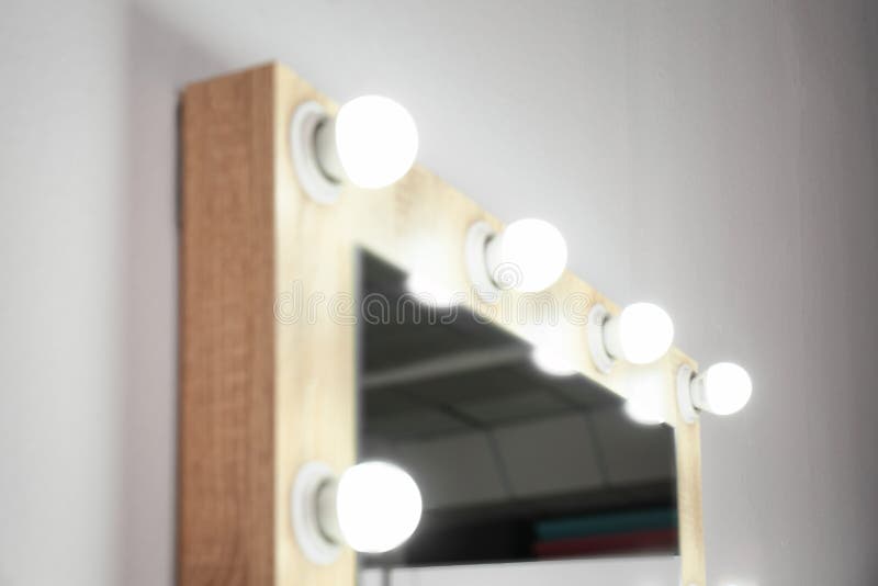 Mirror with Light Bulbs on White Wall, Closeup. Stock Image Image of