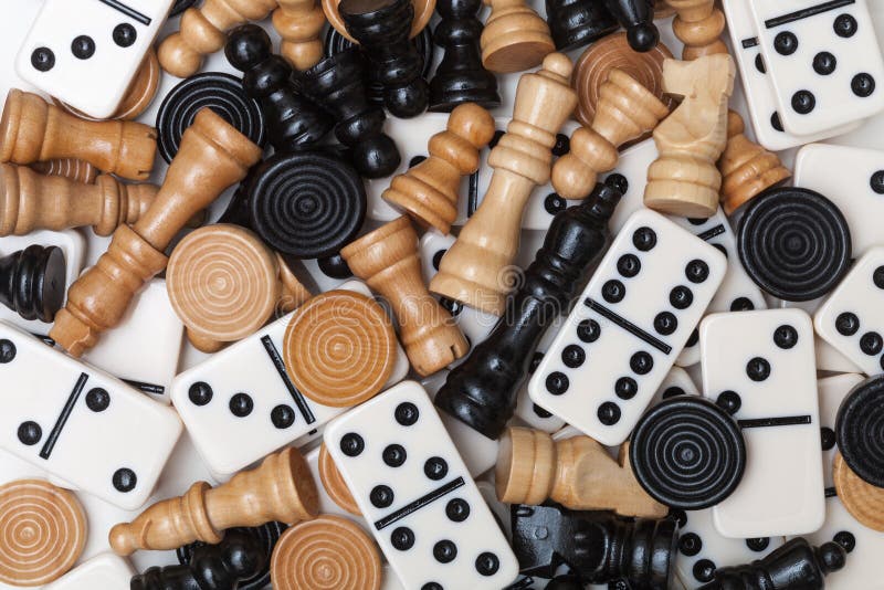 Different Game Pieces on Chessboard Against Blurred Background, Closeup
