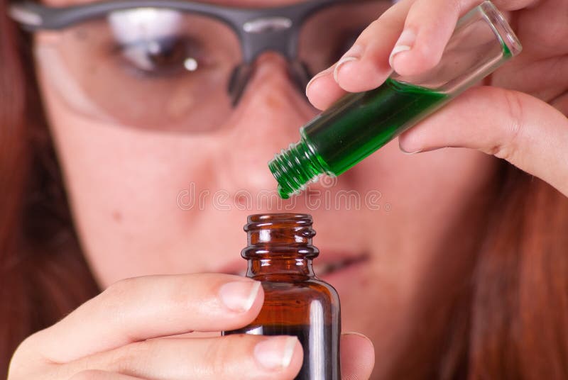 Scientist Mixing Experimental Green Liquids. Scientist Mixing Experimental Green Liquids