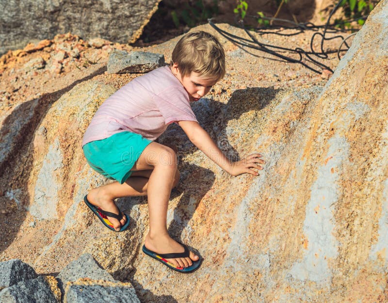 Mischievous Hooligan Playful Boy Climbs Rock Stone in Flip Flops ...