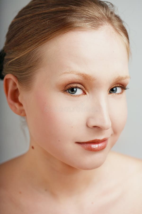 Close-up portrait of pretty blond girl with suspicious facial expression. Close-up portrait of pretty blond girl with suspicious facial expression