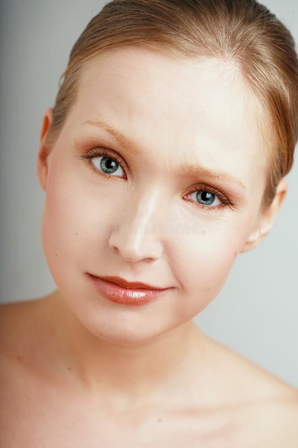 Close-up portrait of young blond girl with mistrustful facial expression. Close-up portrait of young blond girl with mistrustful facial expression