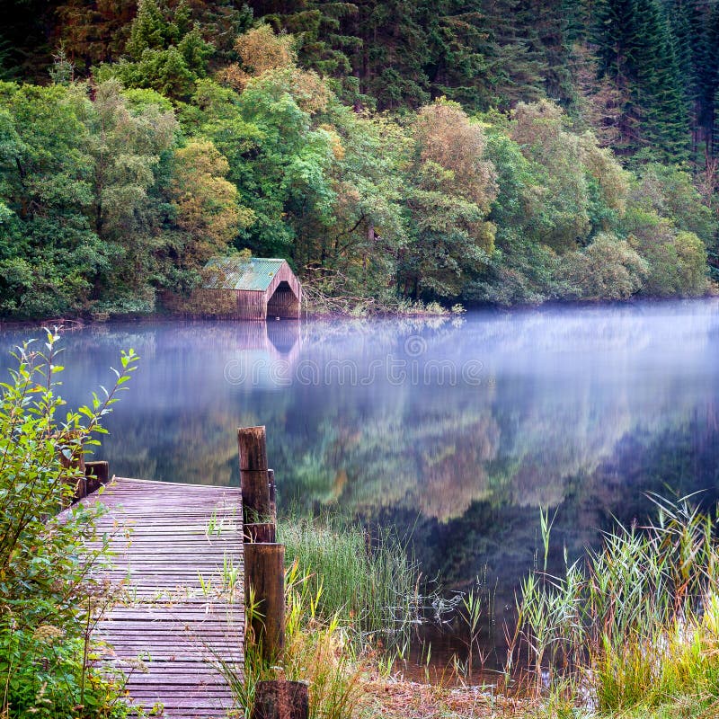 The old wooden jetty and boathouse on Loch Ard in the Scottish highlands. The old wooden jetty and boathouse on Loch Ard in the Scottish highlands