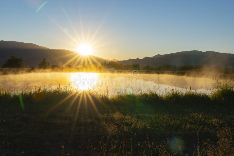 Mist rises over pond as sunrises and warms the air in rural Cromwell