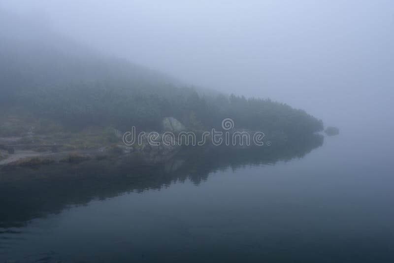 Misty morning view in wet mountain area in slovakian tatra. mountain lake panorama