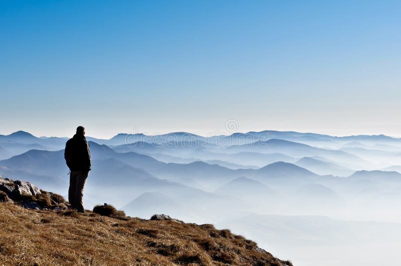 Misty mountain hills and man silhouette