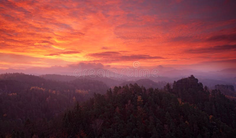 Misty red morning landscape. Morning landspace with fog. Sunrise in landscape. Sun during sunrise in czech national park Ceske Svy