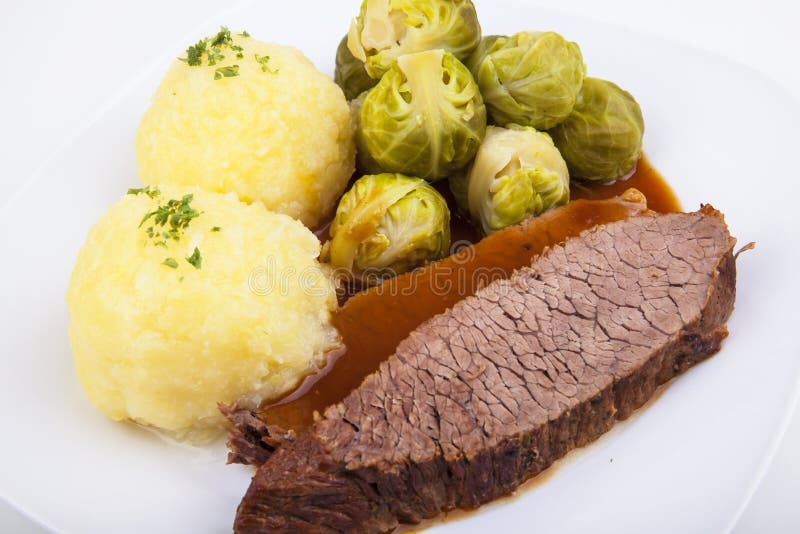 Sauerbraten with Klößen and Brussels sprout. Sauerbraten with Klößen and Brussels sprout