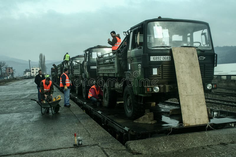 MITROVICA, KOSOVO - FEBRUARY 17, 2009: French army truck being shipped on a train, ready to leave the train station of Mitrovica