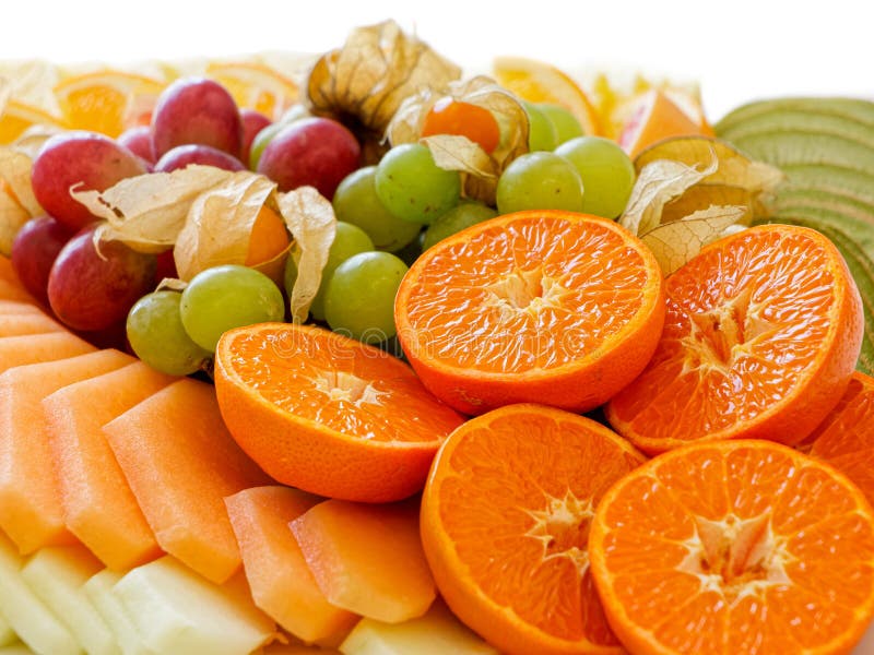 Mix of Arranged Freshly Cut Tropical and Citrus Fruit Isolated on White