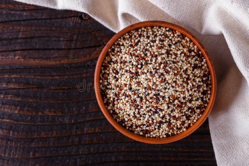Mix of Quinoa Grains on Dark Wooden Rustic Background Stock Photo
