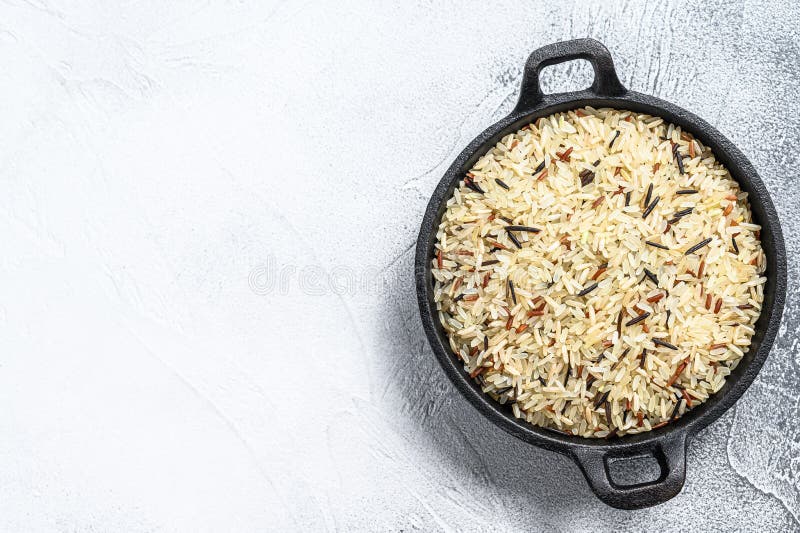Mix Rice in a Castiron Pan. White Background. Top View Stock Photo