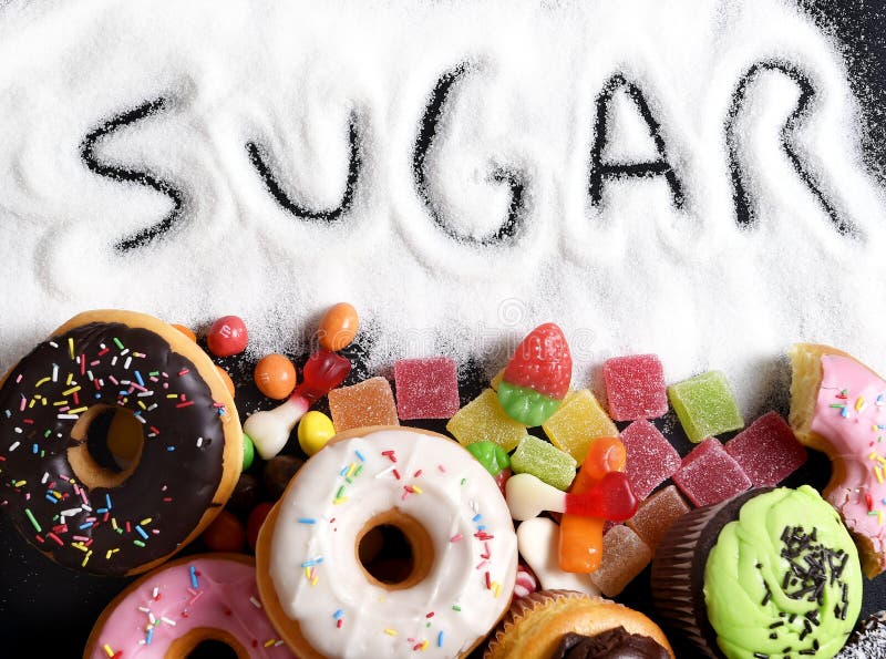 Mix of sweet cakes, donuts and candy with sugar spread and written text in unhealthy nutrition