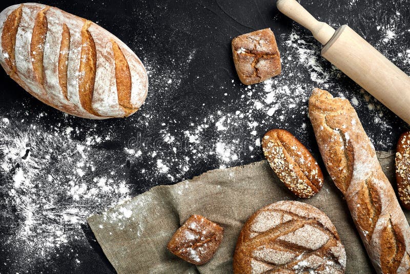 Mixed breads on black table. Top view with copy space. stock images Mixed breads on black table. Top view with copy space. stock images